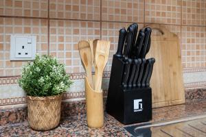 two wooden utensils are sitting on a kitchen counter at Cozy 1 Br Apartment In Axis 2 Residence Dso in Dubai