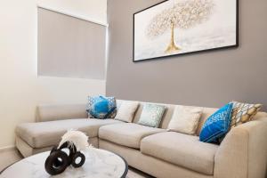a living room with a couch and a table at Cozy 1 Br Apartment In Axis 2 Residence Dso in Dubai