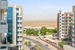 an aerial view of a city with tall buildings at Cozy 1 Br Apartment In Axis 2 Residence Dso in Dubai