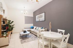 a living room with a couch and a table at Cozy 1 Br Apartment In Axis 2 Residence Dso in Dubai
