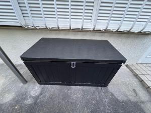 a black box sitting in front of a building at 千住4丁目2階 日本の和のお部屋スカイツリー9分秋葉原10分浅草12分 in Tokyo