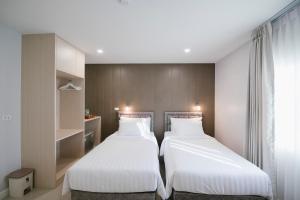 Postel nebo postele na pokoji v ubytování Eng Fah Luang Hotel
