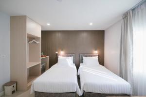 Postel nebo postele na pokoji v ubytování Eng Fah Luang Hotel