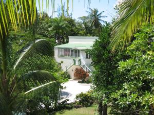 a white house in the middle of trees at The Legend Garden Condos in Saint Peter