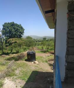 a view from the window of a house at Room With Balcony In Family Farm House UK Host in Arusha