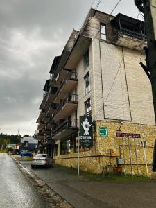 a building with a car parked in front of it at Rest in Bakuriani in Bakuriani