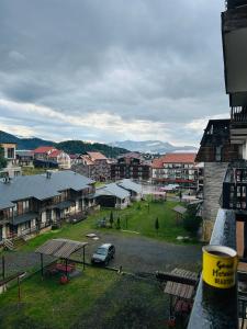 a view of a city with houses and a parking lot at Rest in Bakuriani in Bakuriani +5 photos