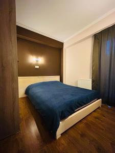 a bedroom with a bed with a blue blanket at Rest in Bakuriani in Bakuriani