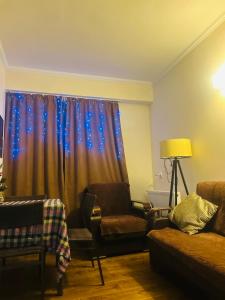 a living room with a couch and a window with stars at Rest in Bakuriani in Bakuriani