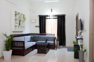 a living room with a couch and a table at Morning Hills in Munnar