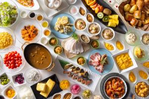 a table full of different types of food on plates at Kichijoji Tokyu REI Hotel in Musashino