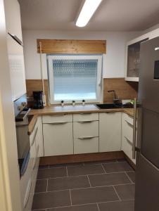 a kitchen with a sink and a window at Apartment Liv for a short break in Gerabronn