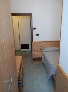 Postel nebo postele na pokoji v ubytování Hotel Cristallo