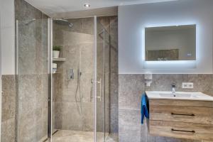 a bathroom with a shower and a sink at Ferienwohnung Nusslberg in Kiefersfelden +34 photos