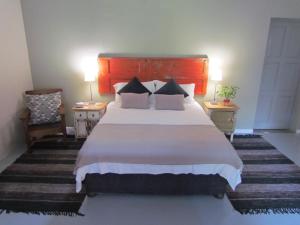 a bedroom with a large bed and two night stands at Caledon 31 in George