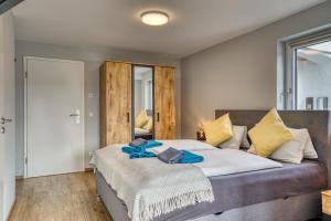 a bedroom with a large bed with blue towels on it at Ferienwohnung Nusslberg in Kiefersfelden