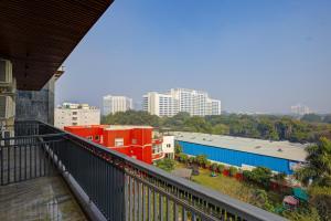 a balcony with a view of a city at Limewood Stay Premium Studios - Near Sector 29 in Gurgaon