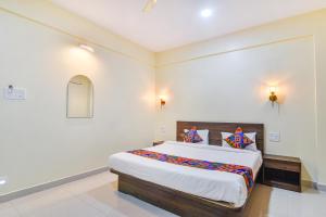 a bedroom with a large bed in a room at Fabhotel Baga Tulip - 500M From Baga Beach in Baga