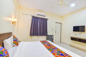 a hotel room with a bed and a tv at Fabhotel Baga Tulip - 500M From Baga Beach in Baga +18 photos