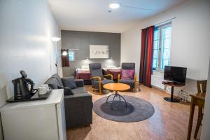 a living room with a couch and a table at Hyvärilä Youth- and Holiday Centre in Nurmes