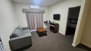 a living room with a couch and a television at Bunbury Stay at Sanctuary Resort Strata in Bunbury