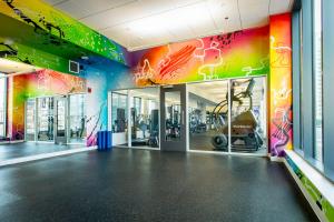 a gym with a colorful wall with exercise equipment at Blueground River North pool AC nr park CHI-1193 in Chicago