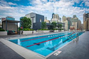 a large swimming pool with a city skyline in the background at Blueground River North pool AC nr park CHI-1193 in Chicago