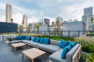 a rooftop patio with blue pillows on a city skyline at Blueground River North pool AC nr park CHI-1193 in Chicago