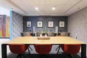 a conference room with a large wooden table and chairs at Blueground River North pool AC nr park CHI-1193 in Chicago +35 photos