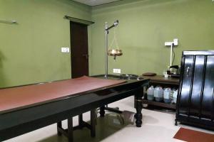 a ping pong table in a room with a ping pongetitive at Cherai Beach Palace in Cherai Beach