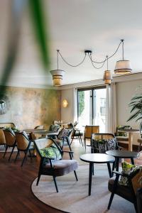 a waiting room with tables and chairs at Hyatt Regency Nice Palais de la Méditerranée in Nice