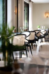 a row of tables and chairs in a restaurant at Hyatt Regency Nice Palais de la Méditerranée in Nice