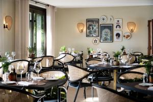 a restaurant with tables and chairs in a room at Hyatt Regency Nice Palais de la Méditerranée in Nice