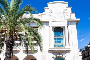 a building with a palm tree in front of it at Hyatt Regency Nice Palais de la Méditerranée in Nice