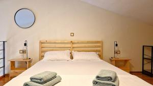 a bedroom with a bed with two towels on it at Sunrise Studio 2 Afitos in Afitos