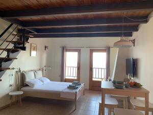 a bedroom with a bed and a table and chairs at Sunrise Studio 2 Afitos in Afitos