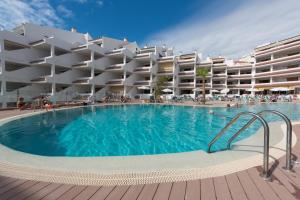 a large swimming pool in front of a hotel at Paloma Beach Apartments in Los Cristianos