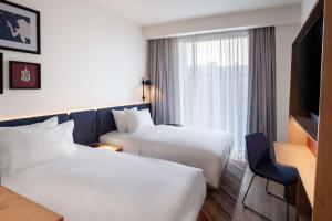 Postel nebo postele na pokoji v ubytování Hampton By Hilton Tallinn