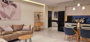 a living room with a couch and a table at Sunset Harmony Apartment in Shkodër