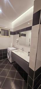 a bathroom with a tub and a sink and a toilet at Sunset Harmony Apartment in Shkodër +15 photos