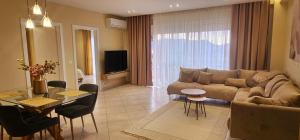 a living room with a couch and a table at Sunset Harmony Apartment in Shkodër