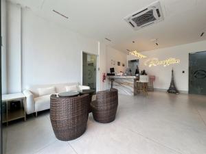 a living room with a couch and a table at Asia Premium Hotel Kuala Terengganu in Kuala Terengganu