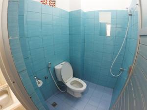 a blue tiled bathroom with a toilet and a sink at Uluwatu Made Guesthouse in Uluwatu +24 photos