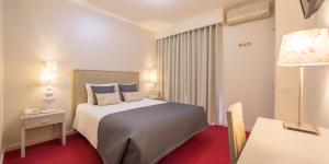 Postel nebo postele na pokoji v ubytování Hotel Lagoa dos Pastorinhos