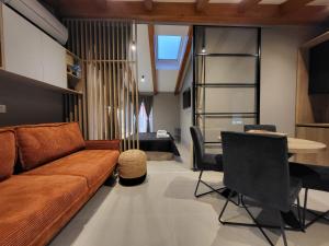 a living room with a couch and a table at Apartman San Zuian in Bale +2 photos