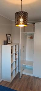 a room with a white cabinet and a light at Apartament Blue in Płock +6 photos