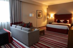 Een bed of bedden in een kamer bij Wonder Palace Hotel Qatar