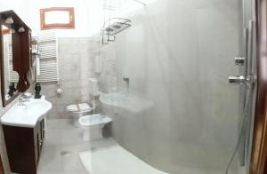 a white bathroom with a shower and a toilet at Angolo Fiorito in Agerola +128 photos