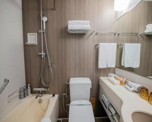 a bathroom with a toilet and a sink and a shower at Shibuya Excel Hotel Tokyu in Tokyo