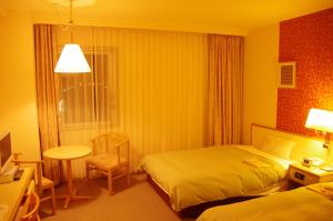 Voodi või voodid majutusasutuse Hotel Sunroute Goshogawara toas